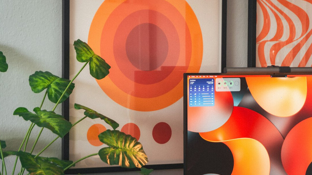 Monitor with colourful programming code on a desk