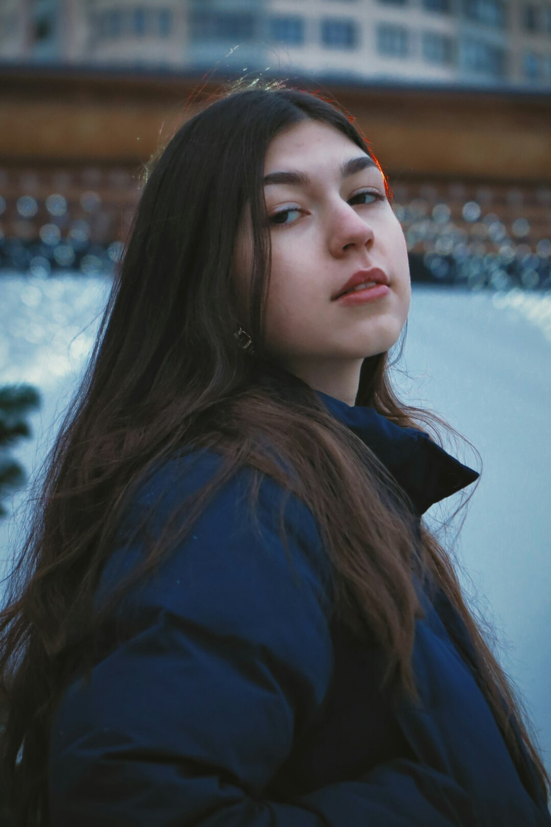 Portrait of a young woman with long dark hair