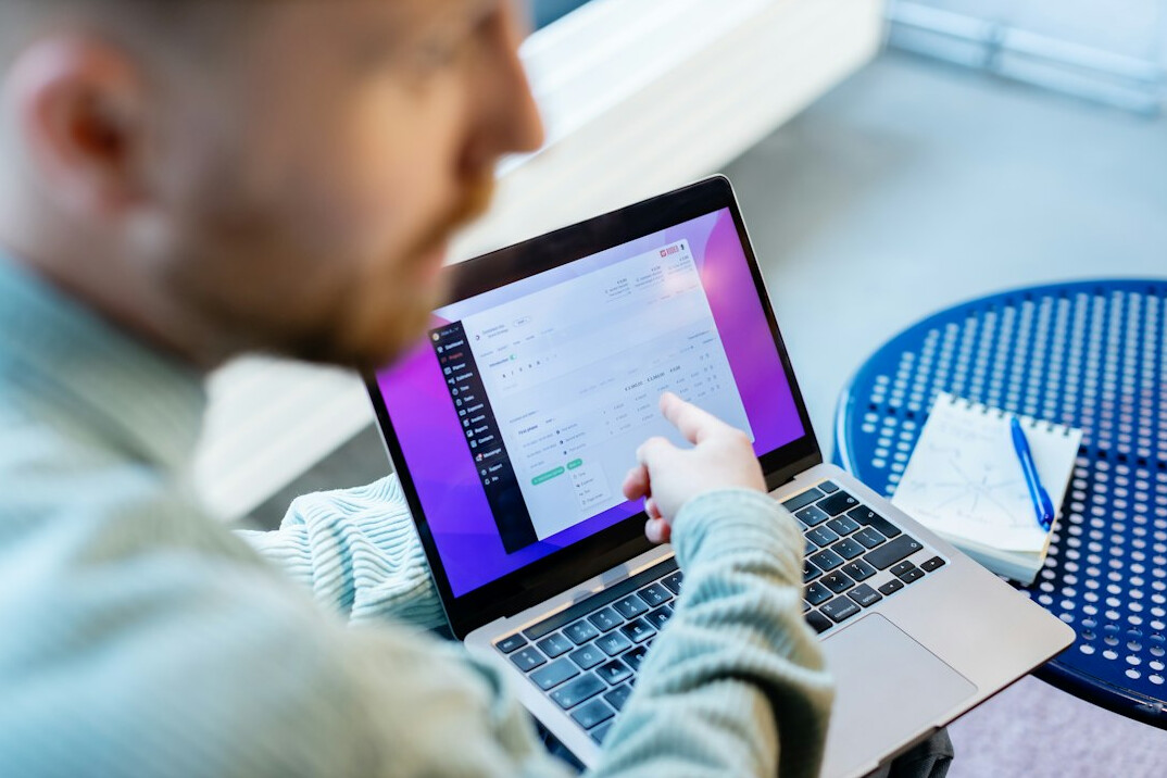young person coding on laptop